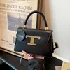 Bolso de mano pequeño cuadrado elegante y texturizado, el bolso de hombro de moda de este año, bolso cruzado casual de nicho simple y versátil al por mayor