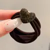 Coloridos coleteros de nuevo estilo 2026, versátiles y dulces, con accesorios de M&M's, anillos de toalla, diseños de dibujos animados y un estilo fresco y lindo, perfectos para accesorios para el cabello de niños