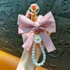 Llavero Colgante de Moño con Perlas de Alta Venta Transfronteriza Accesorios Creativos de Nudo de Tela de Cinta de Colores Accesorios para Funda de Auriculares Bolsa