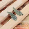 Accesorios de joyería NIANXING 30*9mm alas dobles plumas