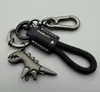 Lindo llavero de pequeño dinosaurio de dibujos animados, exquisito llavero de coche para niña, llavero con correa de cuero, colgante de mochila, regalo