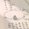 Pulsera Popular Nueva de Esmalte Azul Forma de Calabaza Estilo Chino de Xiaohongshu para Mujeres, Chapada en Oro de 18 Quilates e Incrustada con Diamantes Rojos, con Esmalte de Goteo para la Buena Fortuna y la Prosperidad