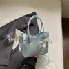 2026 nuevo bolso tejido de nicho de alta gama, bolso tipo cubo, bolso tipo dumpling, bolso simple y elegante de alta gama para llevar debajo del brazo para mujer