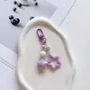 Nuevo llavero colgante color estrella de cinco puntas campana pintada accesorios set de auriculares colgante para bolso