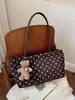 Bolso de mano, bolso de hombro y bolso de axila nuevo estilo coreano, de nicho y exquisito para el trabajo, con diseño de bolsa tote de lunares para mujer, 2026