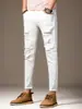 Calça de ganga masculina estilo coreano, de nove pontos, com rasgos, corte slim, perna afunilada, elástica, para primavera e outono, novo estilo branco, calça de nove pontos desgastada