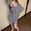 Ropa infantil estilo coreano para niñas, conjunto ligero de verano, nuevo modelo 2026, extremadamente elegante y atractivo, camiseta de manga corta y shorts con estampado de dibujos animados en gris