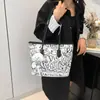 Bolso de lona con grafiti para mujer, nuevo bolso de hombro informal de 2024, combinable, de gran capacidad, para estudiantes y viajeros.
