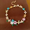 Collar de mariposa con flor de circón bañado en oro real y perlas, cadena para la clavícula de lujo discreto, juego de joyería de estilo dulce exquisito