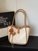 Bolsas de mano para mujer transfronterizas, nuevo modelo 2026, bolso de hombro y bandolera de alta gama a la moda para mujer, bolso de mano simple para el día a día, bolso tipo cubo