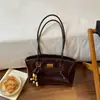 2026 Nova Bolsa de Mão Texturizada Retro de Nicho da Moda para Mulheres Estudantes Universitárias Casual para o Trabalho Bolsa Tote de Ombro Único