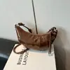 Bolsas de nicho transfronteiriças femininas 2026 bolsa versátil de ombro único e transversal bolsa de croissant super quente da moda nova bolsa popular leve