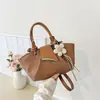 Bolso de mano de diseño de nicho de alto valor 2026 verano nuevo retro casual sensación relajada bolso de cubo de un solo hombro cruzado