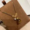 "Latido Ámbar" Colgante Círculo Piedra Ojo de Tigre Melard, Cadena Clavícula Negra Dorada de Alta Gama Estilo Chanel para Mujer