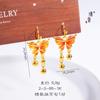 Tienda de oro Jin Yan con pendientes de borla de mariposa de sueño de lluvia de humo de oro de arena esmalte degradado para mujer gancho de oreja de alta gama regalo