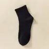 Medias clásicas en blanco y negro y gris para hombre y mujer, de color liso, con cintura antideslizante, de tubo medio, para deportes, informales, transpirables, de algodón.