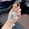 Llavero de arcilla de moda con signo de dólar incrustado de diamantes, cadena de perlas, colgante para bolso, colgante creativo de la fortuna, llavero