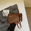 Bolso de mano de moda retro para mujer, versión coreana, bolso cuadrado pequeño casual simple, nuevo bolso de nicho de alta gama 2026