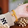 Tiktok pequeño libro rojo Pulsera de tres círculos del mismo estilo dulce y lindo pulsera de flor de loto de tres generaciones Vietnam arena oro mujer