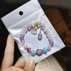 Libro Caperucita Roja Mismo Estilo Estudiante Pulsera de Glaseado de Palomitas de Maíz Hecha a Mano con Cuentas Dibujos Animados Cristal Pulsera Infantil Venta al por Mayor Cajas de Regalo