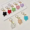 Nova Chaveiro Trevo de Quatro Folhas Cheio de Diamantes de Argila de Cristal Exquisito Pingente de Carro com Pedras Strass Embutidas Bolsa de Luxo Leve