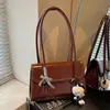 Bolsa versátil transfronteiriça 2026 outono nova moda feminina estilo coreano design de nicho bolsa de ombro sob o braço de alta qualidade