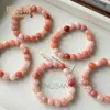Venta al por mayor del fabricante Pulsera de Flor de Durazno Original de Xinjiang Natural Jade Oro Seda Jade Flor de Durazno Relleno Polvo de Cristal Rosa