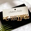 Nuevo conjunto de pendientes de oro laminado de tamaño degradado minimalista de lujo ligero transfronterizo, disponible en múltiples estilos para venta al por mayor, se puede usar en capas.