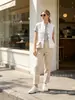 Moda al por mayor para mujer europea y americana 2026: Chal de Trabajo Elegante y Estiloso con Cordón, Bolsillo Elástico Abotonado y Cuello Alto