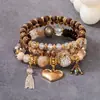 Produto popular de travessia de fronteira europeu e americano: Pulseira com pingente de coração estilo boho, pulseira de contas com cordão elástico multicamadas