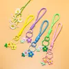 Venta al por mayor de pequeños, frescos, estilo coreano, flor de girasol acrílica, flor de goma suave, cordón trenzado hecho a mano, accesorios para cordón de teléfono