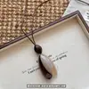 Novo pingente estilo chinês colar longo irregular novo estilo feminino sensação de alta qualidade acessórios de corrente para suéter outono e inverno design de nicho