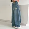 Calça Jeans Feminina Outono 2026 Novo Estilo Infantil Primavera e Outono Calça de Perna Curva com Flores Crianças Médias e Grandes Roupas de Outono Soltas Calças Tendência