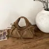 Bolso de mano de diseño nicho estilo coreano nuevo para principios de otoño 2026, bolso de hombro y cruzado de alta gama para commuting, bolso tipo empanada