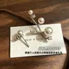 Pendientes de botón de rama asimétrica de perla estilo francés para mujer, nuevos, pequeños, de nicho, con temperamento, incrustaciones de perla, strass, rama, versátiles, de lujo ligero