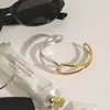 Diseño silencioso acero inoxidable oro de 18 quilates color oro y plata a juego líneas minimalistas pulsera abierta hueca anudada en espiral