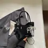 Bolsa Saco Textura Trançada Retrô Feminina 2026 Nova Tendência Moda Versátil Ombro Transversal Bolsa de Mão com Toque de Luxo