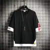 Moda Verão 2024 Marca Falsa Peça Dupla Camiseta de Manga Curta Masculina Estilo Hong Kong Solta Casual Versátil Casal Vestido de Meia-manga