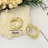 Pendientes de moda transfronterizos con un toque de alta gama, acero inoxidable dorado de 18 quilates, elegante diseño circular, versátiles pendientes de tachuela geométricos de acero de titanio para mujer