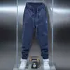 Coleção masculina de primavera da moda: calças casuais de cor sólida, calças jogger de novo estilo, calças slim fit elásticas e versáteis, pretas