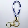 Venta al por mayor del fabricante Llavero de Cuerda de Aleación Tejida y Cuero Accesorios Colgantes Material PU Bolsas Pequeñas de Regalo Accesorios para Llaveros