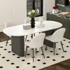 Mesa de comedor de color crema, moderna y lujosa con tapa de piedra para uso doméstico, con un diseño moderno y minimalista de forma ovalada negra, adecuada para comedores