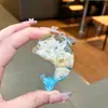 Nuevo llavero de muñeca de delfín con arena movediza relleno de aceite, colgante para mochila, decoración para bolso de pareja, regalo pequeño para venta al por mayor