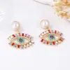 Pendientes de aleación con diseño creativo de alta gama, segunda mano, de lujo ligero, europeos y americanos, con ojo de diablo de diamantes completos y perlas de imitación