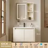 Tocador de baño engrosado y ahorrador de espacio con diseño en color crema, que cuenta con un lavabo redondeado, lavabo cerámico integrado y un lavabo de una sola pieza.