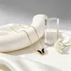 Fabricante de conjunto de joyería de mariposa concha estilo francés transfronterizo, combinación de collar, pulsera y pendientes de nicho de alta gama para mujer