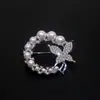 Versión coreana de broche de perla de diamante de alta calidad, moda, hebilla de mariposa anti-luz para bufanda, pasador fino de alta calidad, venta al por mayor de ropa