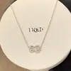 Aretes de oro de 18 quilates de Fred incrustados con diamantes con diseño de nudo doble y elegante collar con borla en forma de pera, un toque de lujo y moda