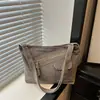 Nuevo bolso de hombro de mezclilla de nicho estilo retro japonés, mochila de lona versátil con bloques de color para estudiantes mujeres