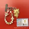 Llavero de tela con logo de empresa personalizado Cadena para teléfono móvil Angela Lámina de oro puro Oro 999 Regalo de aniversario